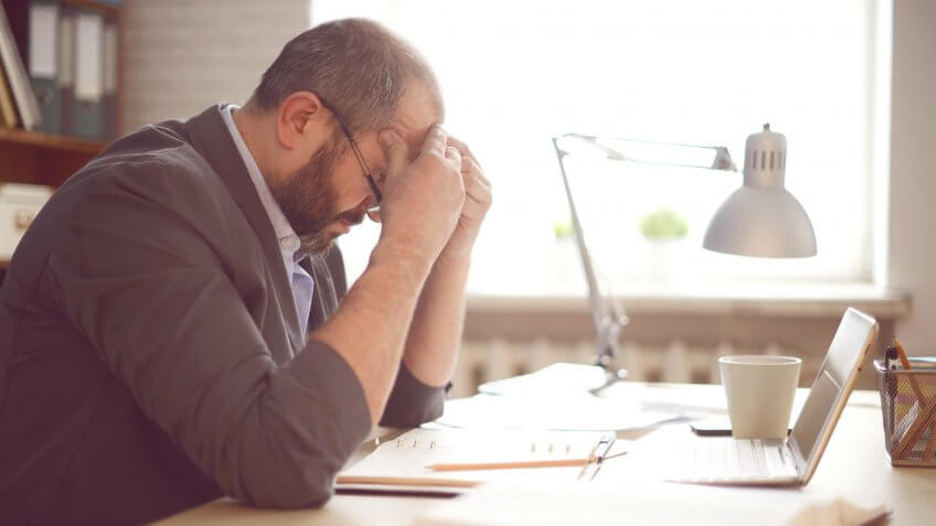 Mature Adult man working in the office.