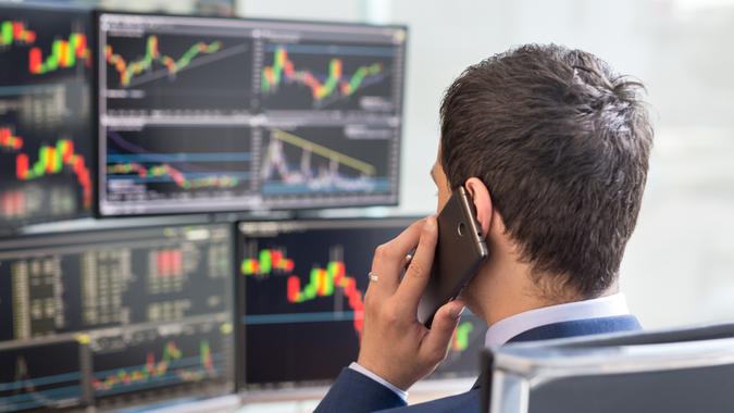 stock broker talking on phone trading stocks