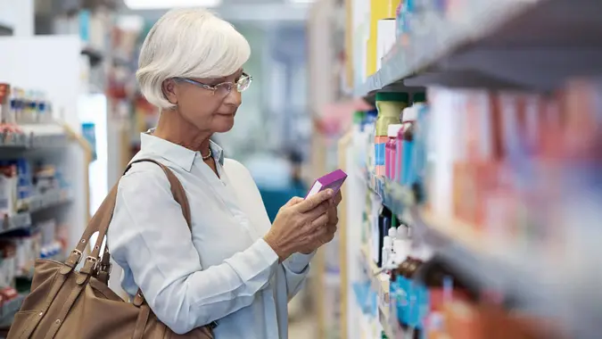 elderly woman looking at products in a pharmacy