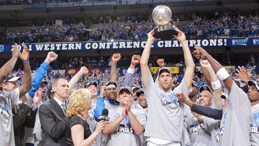 DALLAS, TX - MAY 25: Dirk Nowitzki #41 holds up the trophy in celebration with owner Mark Cuban and the Dallas Mavericks as they celebrate their victory against the Oklahoma City Thunder during Game Five of the Western Conference Finals in the 2011 NBA Playoffs on May 25, 2011 at the American Airlines Center in Dallas, Texas.