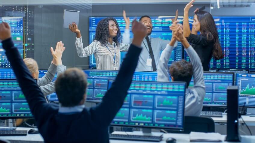 team of investors cheering