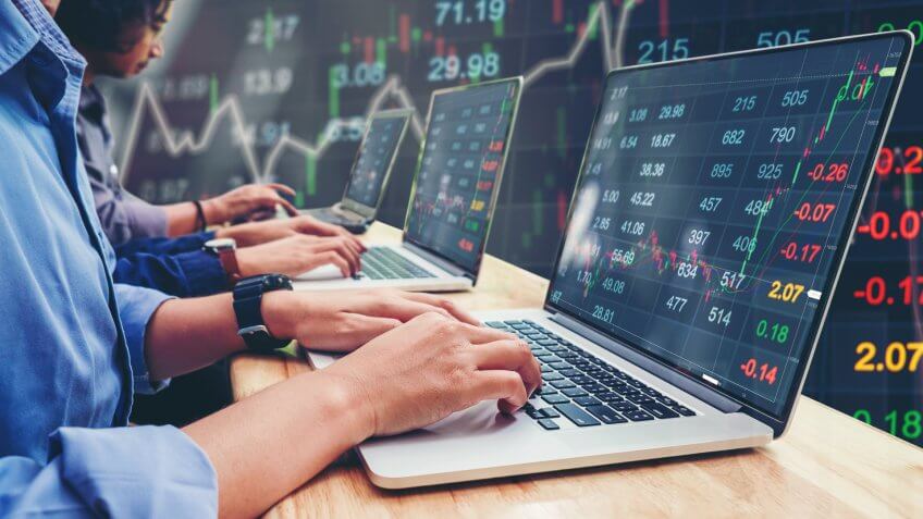 team of investors looking at stocks