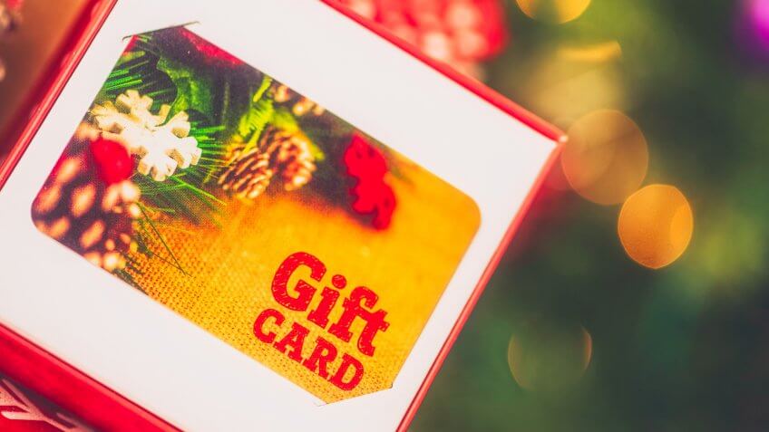 Christmas gift card in opened box in Christmas setting