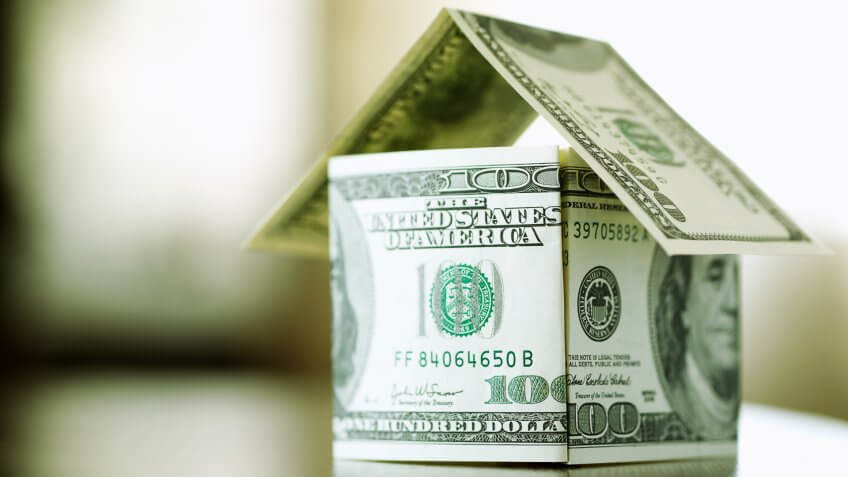 a house made from bills of 100 dollars, dof f/x, selective focus.