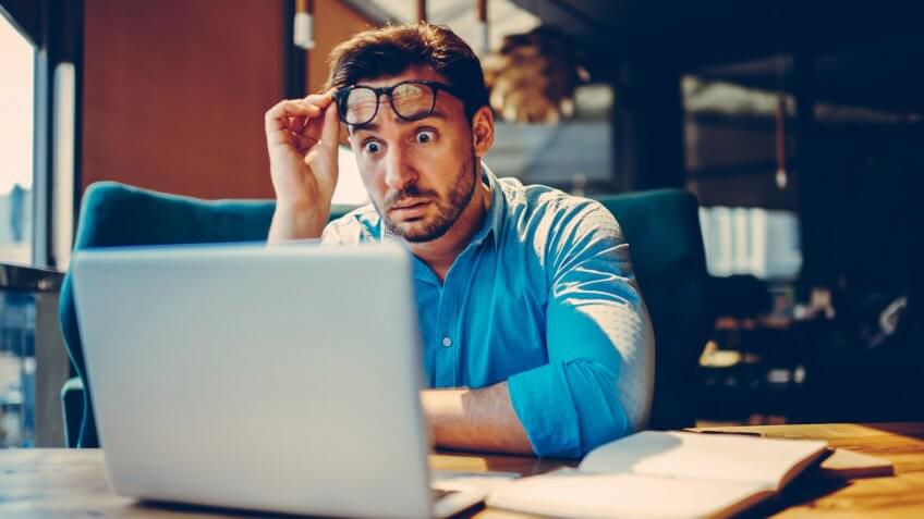 shocked man looking at computer