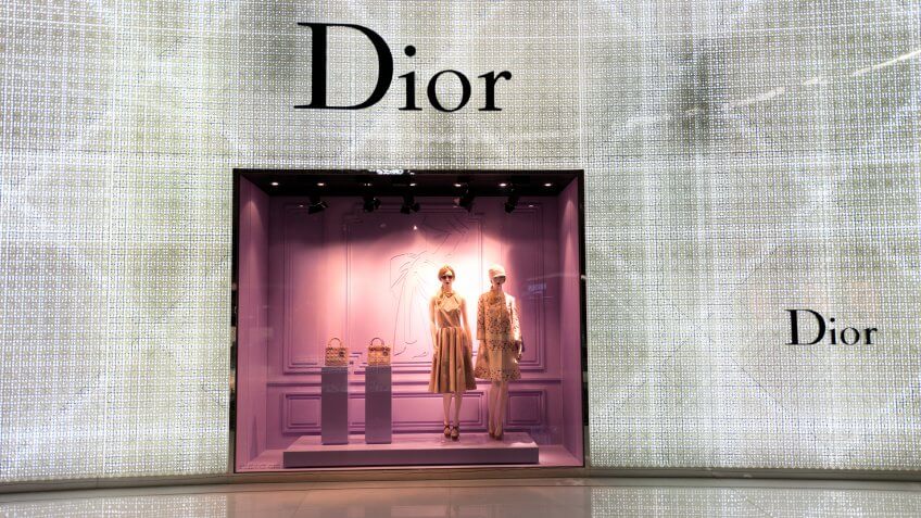 "Dubai, United Arab Emirates - January 17, 2013: Christian Dior designer clothing and handbags in illuminated window display at The Mall of the Emirates.