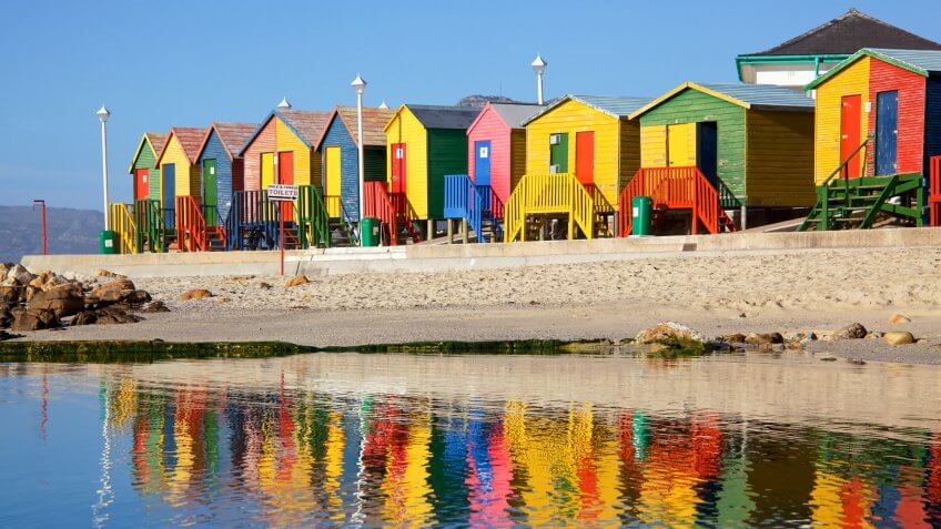 Brightly painted wooden bathing huts at St James Beach, near Cape Town, South Africa.