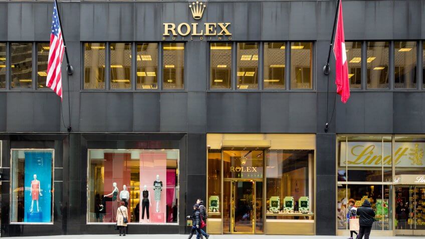 New York City, New York, USA - March 14, 2014: Rolex Store on fashionable Fifth Avenue in Manhattan with pedestrians visible.
