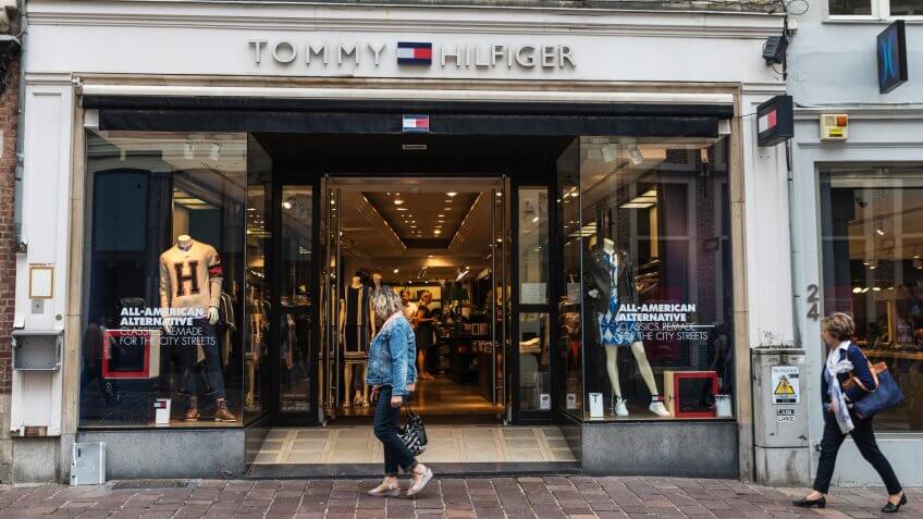 Bruges, Belgium - August 31, 2017: Tommy Hilfiger shop with people around in the historic center of Bruges, Belgium.