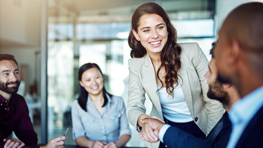 Cropped shot of two businesspeople shaking hands during a meeting in the boardroom.