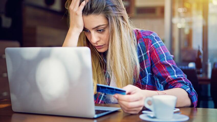 Young girl have problems with her credit card till shopping online.
