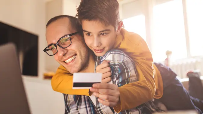 Photo of father with son on line shpping.