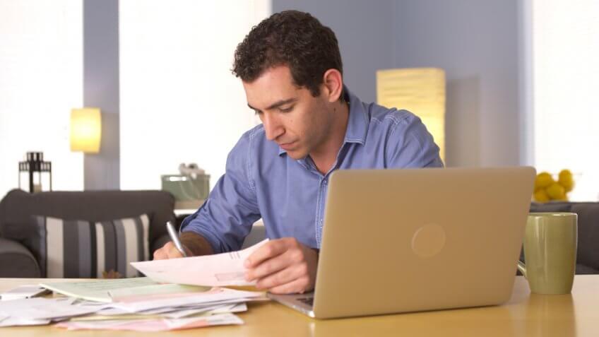 Man doing his taxes at desk.