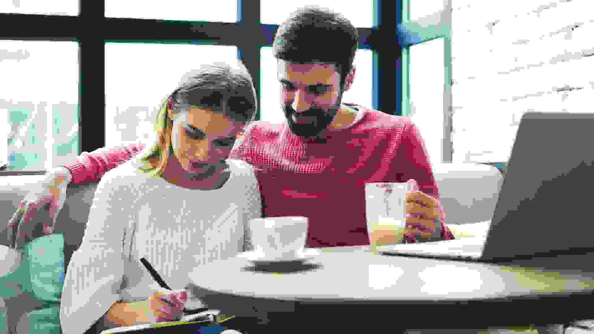 young couple sitting in cozy coffee shop and spending time together having some tea
