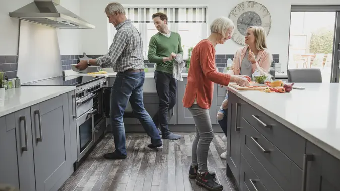 senior parents in the kitchen with adult children