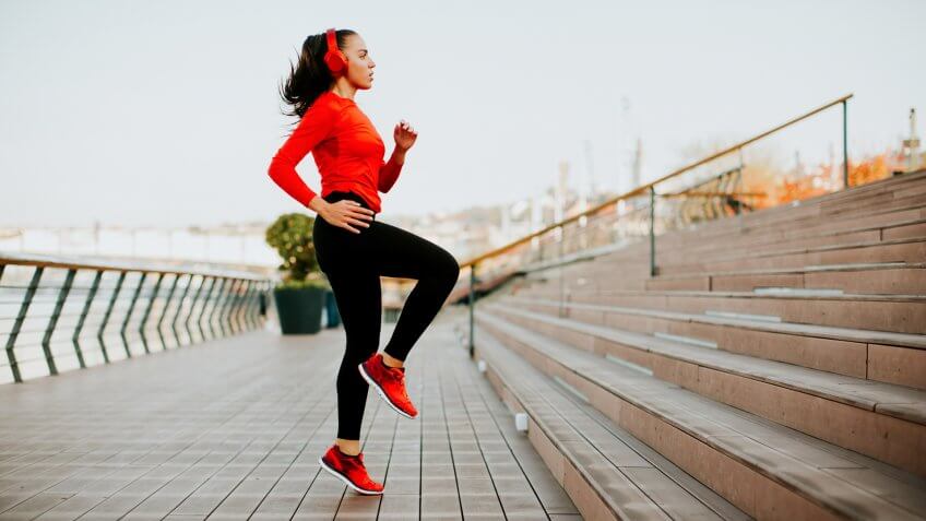 View at young woman exercising outside.