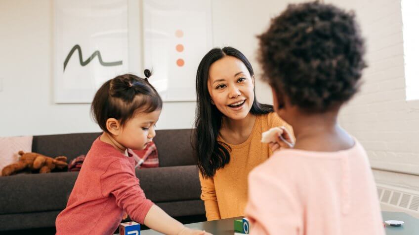 Parent playing with toddlers.