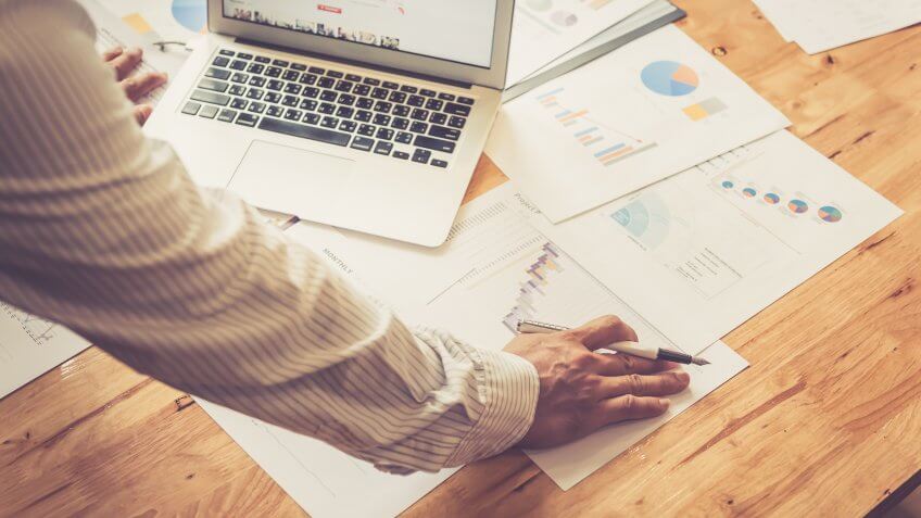 businessman reviewing financial documents and reports