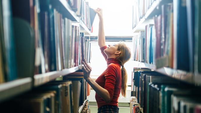 grabbing book in library