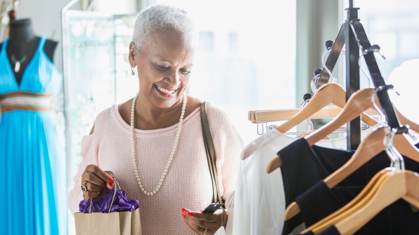 A senior woman shopping in a clothing store.