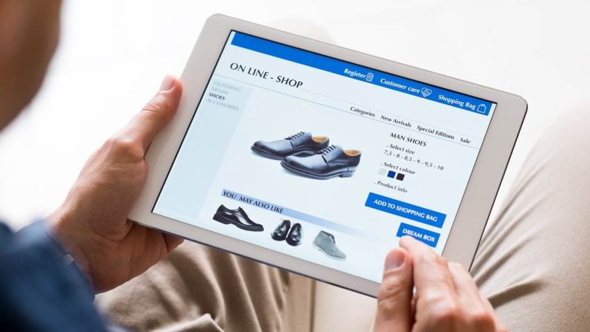 Young man looking at shoes online.