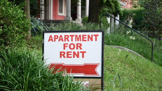 Apartment for rent sign displayed on residental street.
