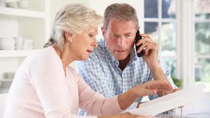 Retired couple with household bills.