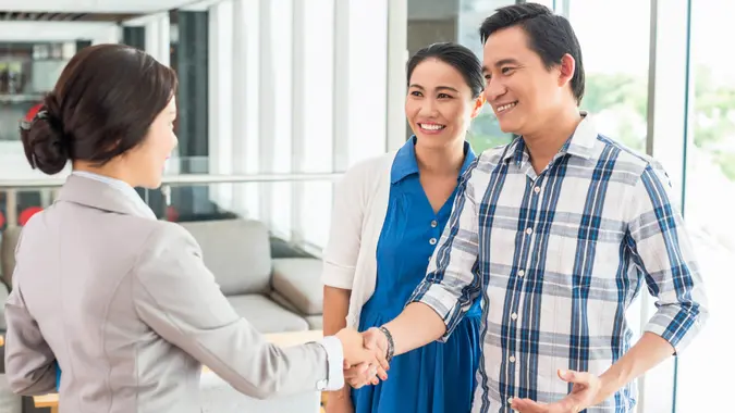 Husband shaking hands with the real estate agent.