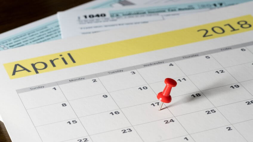 Calendar on top of form 1040 income tax form for 2017 showing tax day for filing is April 17 2018.