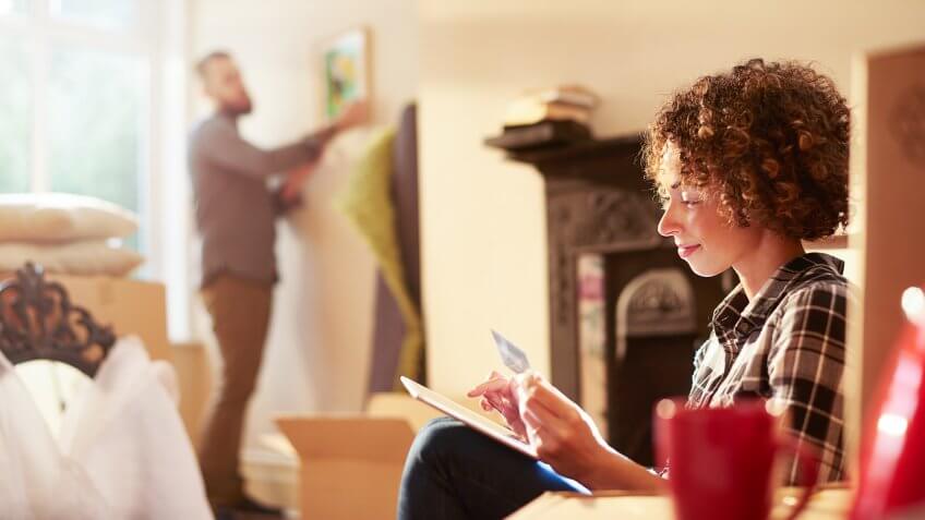 a young couple move into their new home and start to unpack.