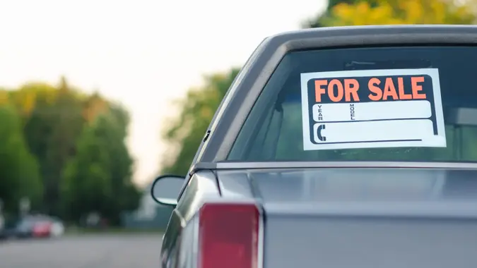 Parked vehicle for sale on a street, with space for own text.