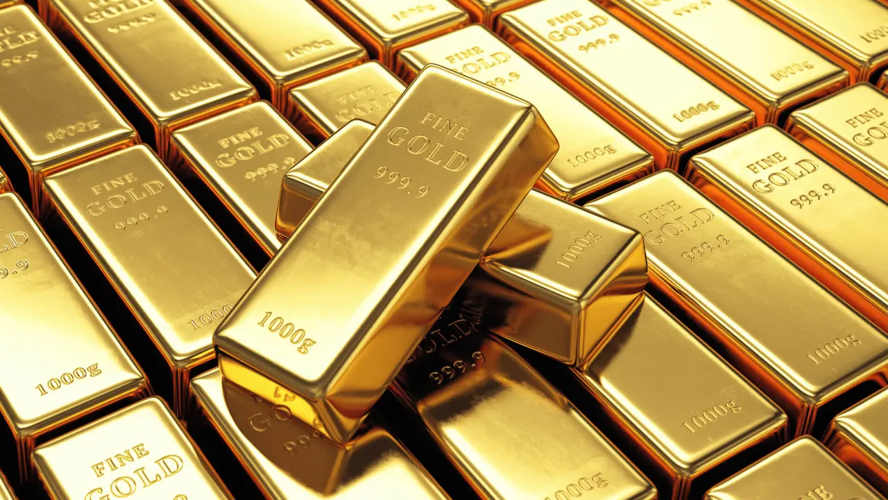 Group of gold bars with two ingots on top.