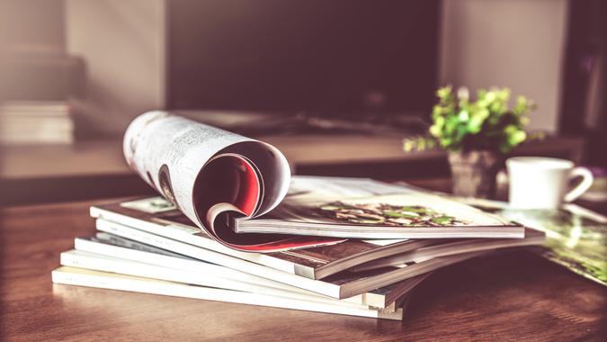 Scam No. 4: Magazine Sales Scams selective focus of the stacking magazine place on table in living room.