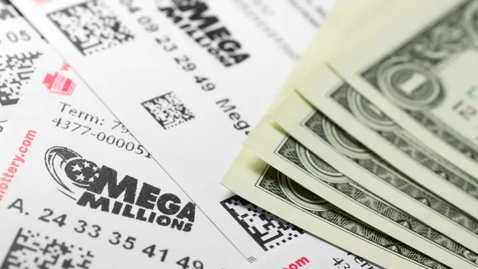 Philadelphia, United States - March 13, 2011: Many Mega Millions lottery tickets and one dollar bills.