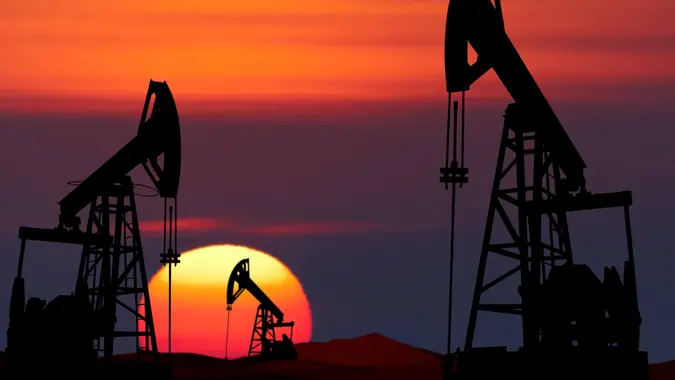 Oil pumps silhouette at colorful sunset.