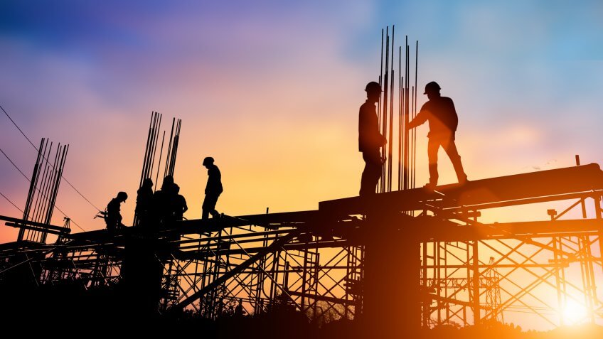 construction site at sunset silhouette of workers