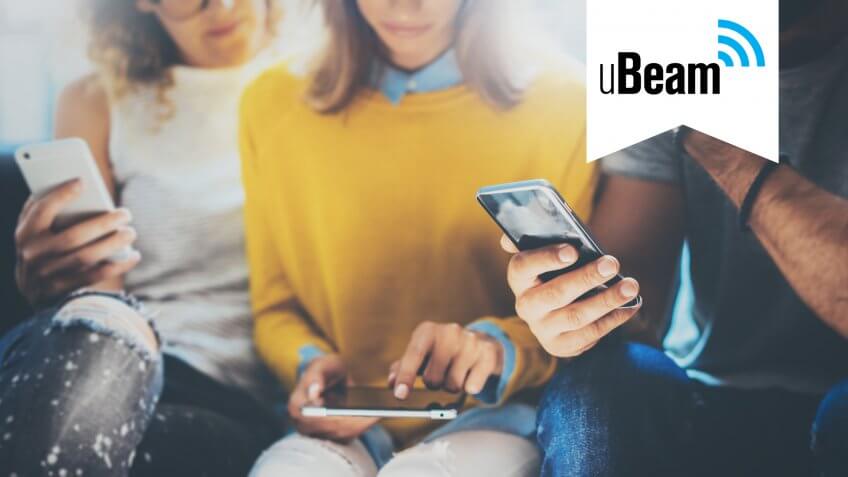 group of friends checking smartphones