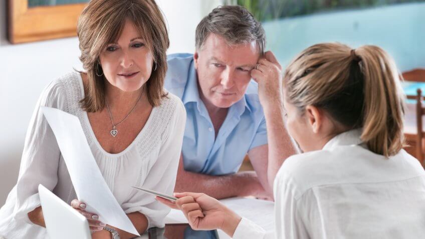 Worried mature Couple in Meeting With Advisor at home.