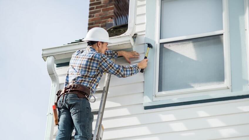 Adult male construction worker working on residence.