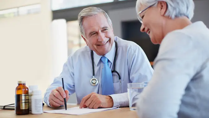 Shot of a doctor prescribing medicine to his senior patienthttp://195.