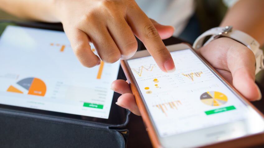 Businesswoman check data in smartphone and tablet.