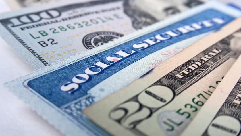 Social security card and American money dollar bills close up concept.