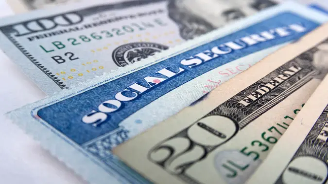 Social security card and American money dollar bills close up concept.