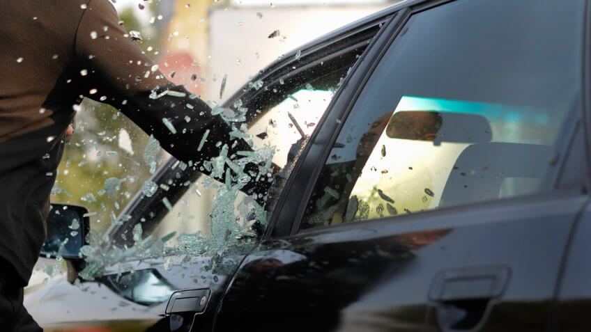 man-breaking-cars-window-million-pieces