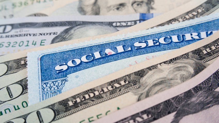 Social security card and American money dollar bills close up concept.