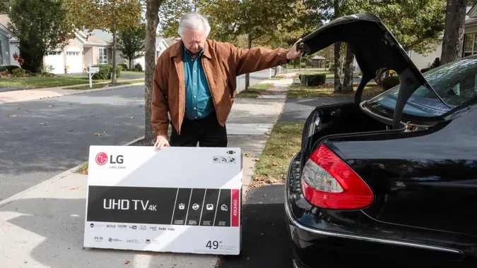 Galloway, United States - October 26, 2016: Series:Senior caucasian man has bought a new flat screen tv for his home.