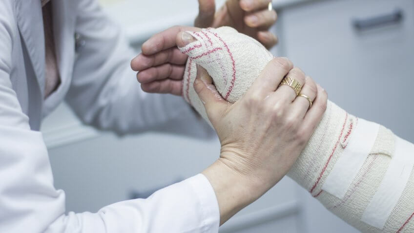 doctor-applying-plaster-cast-bandages-patient