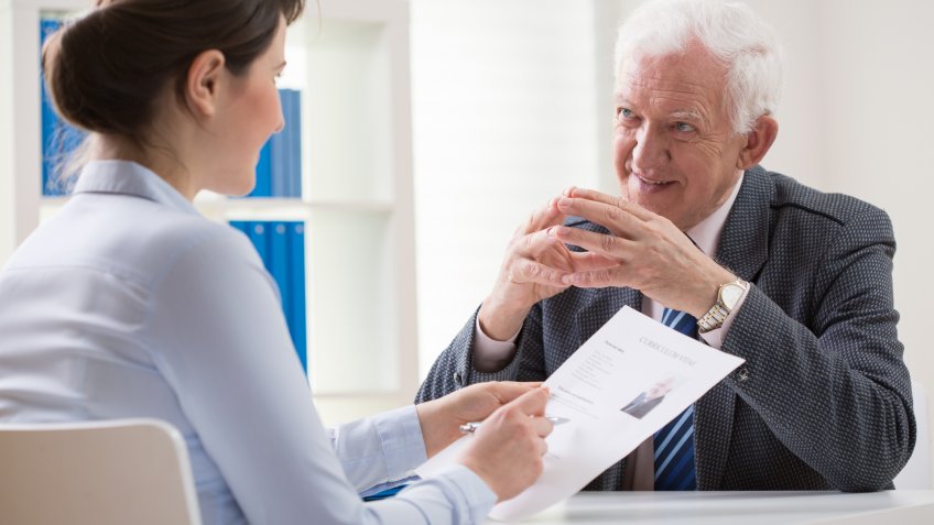 Elder man answering the questions on job interview.