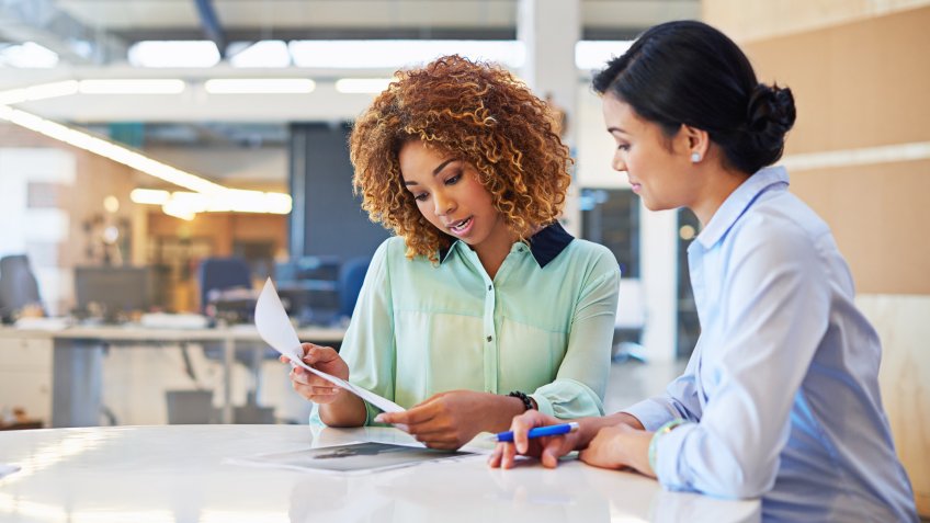 two businesswomen working together in an office