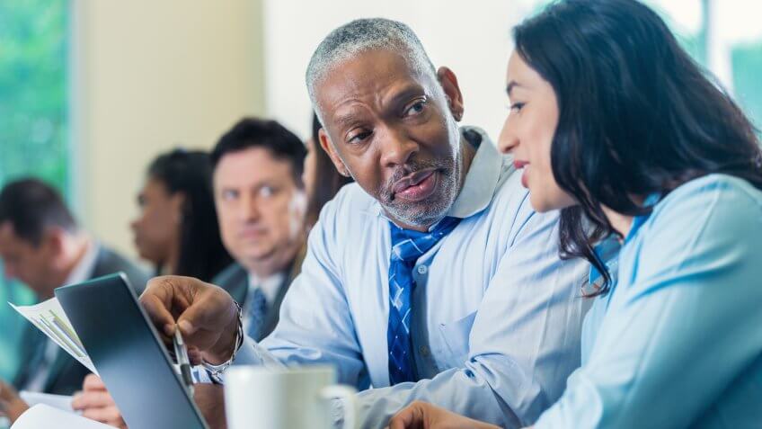 businessman talks with businesswoman at a professional seminar